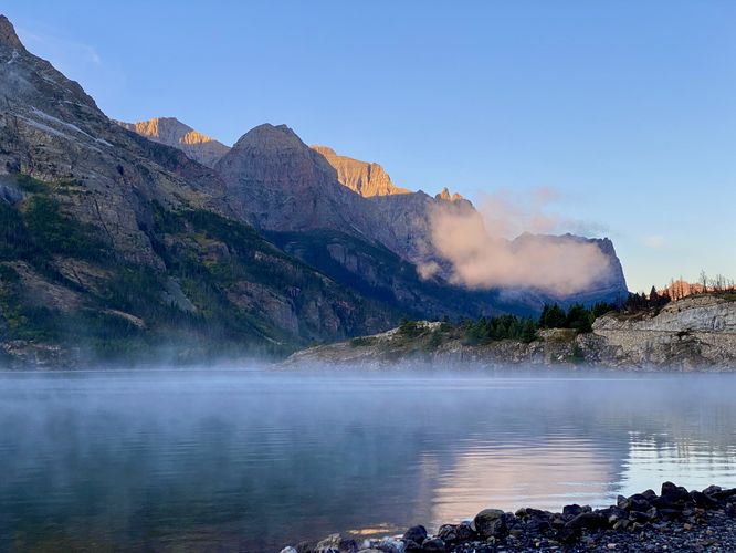 Sunrise over Saint Mary Lake with a view of alpine mountains (left) and the Golden Staircase (right)