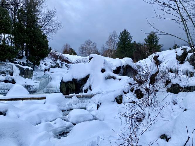 View of the West Branch Ausable River frozen with Flume Waterfalls