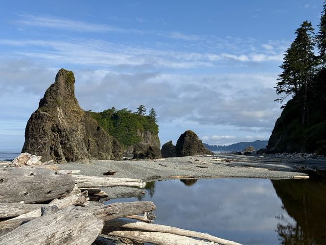 Tidal pool sits in the foreground with Abbey Island and sea stacks in the background