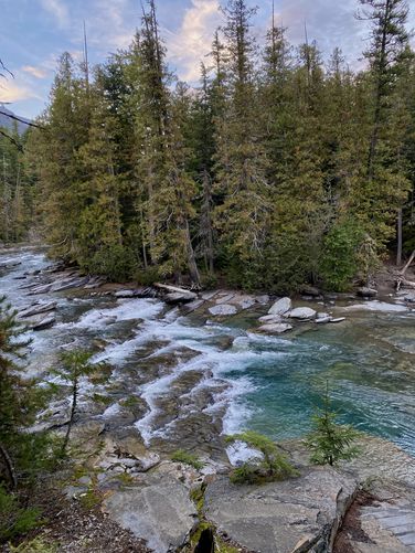 Rapids of McDonald Creek feed into a turquoise pool