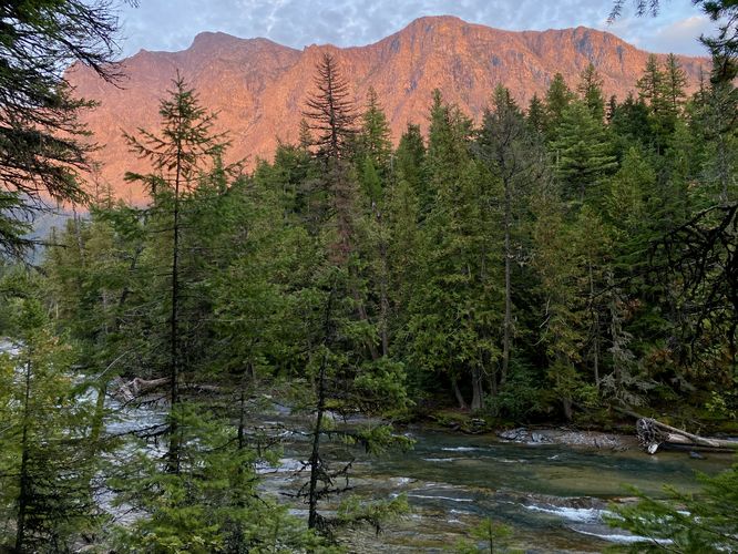 Sunset illuminates Mount Brown, standing above McDonald Creek