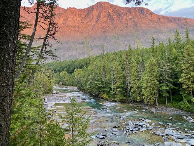Sunset over McDonald Creek, illuminated Mount Brown