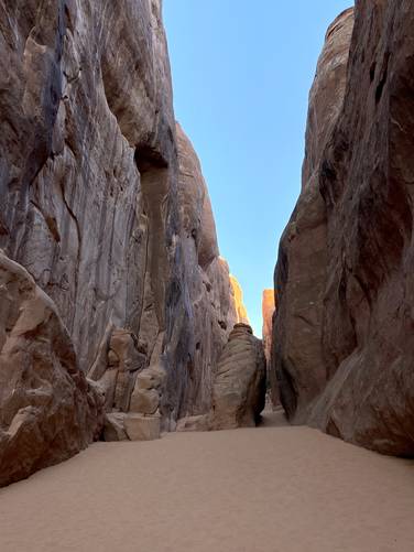 Massive cliffs tower over the trail