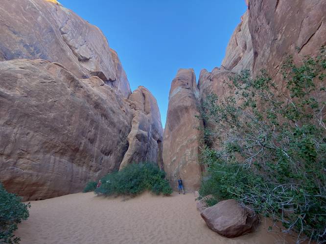 Trail leads to the Sand Dune Arch by passing through a series of massive rock cliffs that tower over the trail