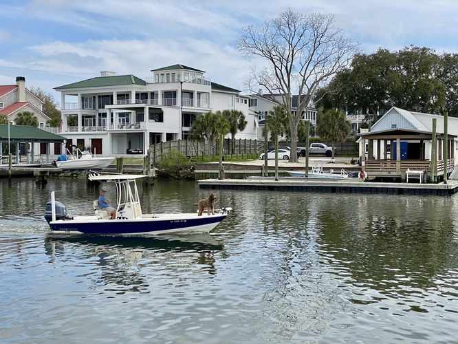 Boater with his dog float down Shem Creek