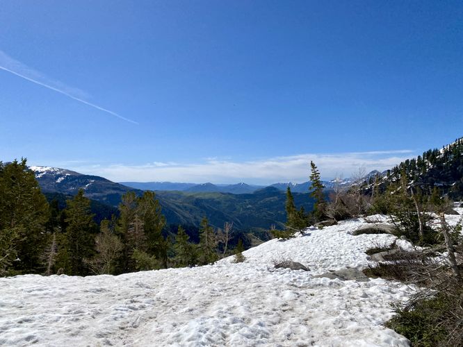 Snowfields cover the mountain by Silver Lake with a view of the Uinta-Wasatch Range