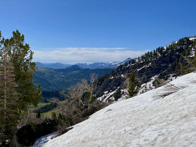 Steep snowfield with a view of mountains from near Silver Lake