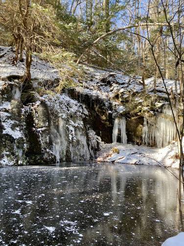 Quarry site (likely soapstone) with deep pool. Frozen over in winter