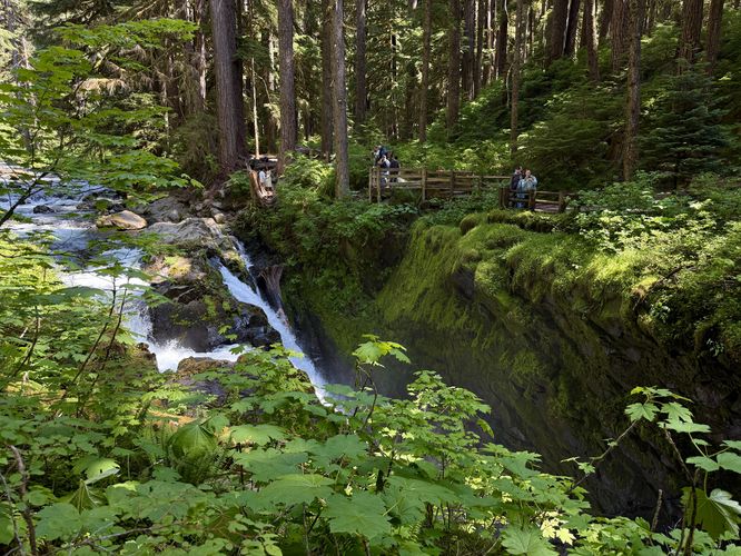 Visitors standing alongside the waterfall