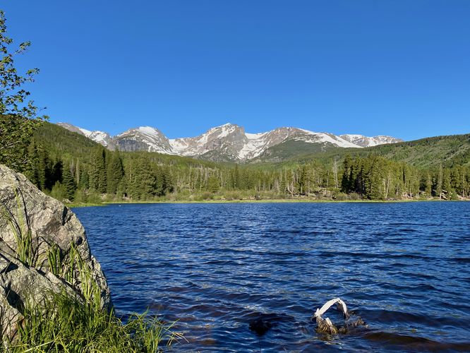 View of Sprague Lake and snow-capped rocky mountains