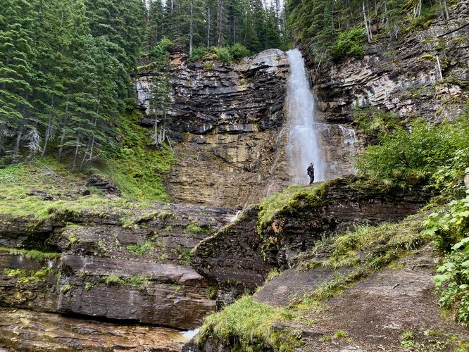 Hiker stands below Upper Virginia Falls
