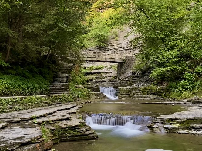 Small waterfalls and a wooden footbridge (long exposure)