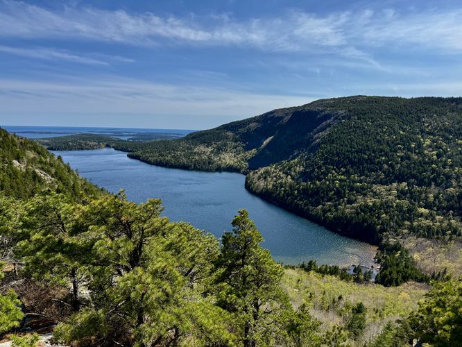 Sweeping views of Jordan Pond, Penobscot Mountain, and the Atlantic Ocean from slopes of North Bubble