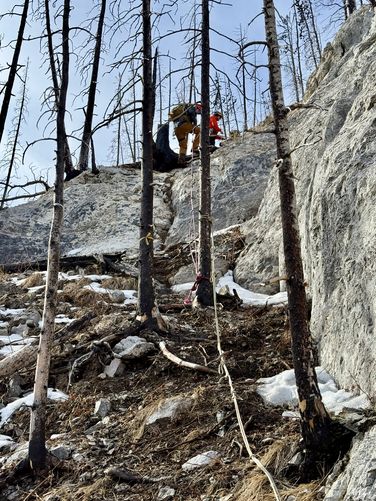 Descending the fixed rope at the cliff