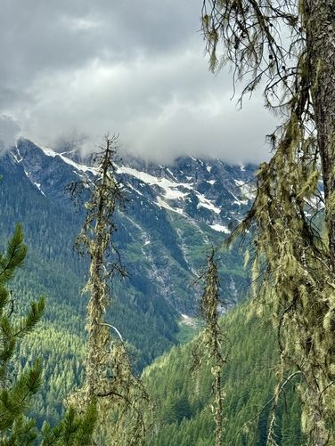 Waterfalls, thousands of feet tall, flow from the snow melt on alpine mountains high above the valley
