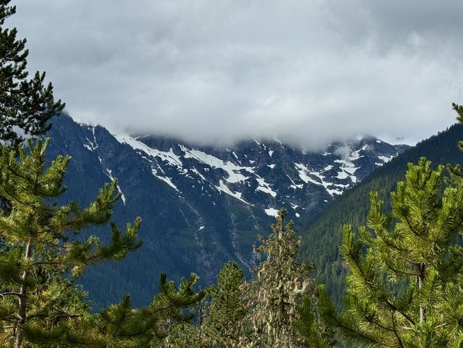 Clouds sit on the alpine peaks that surround the Colonial Glacier