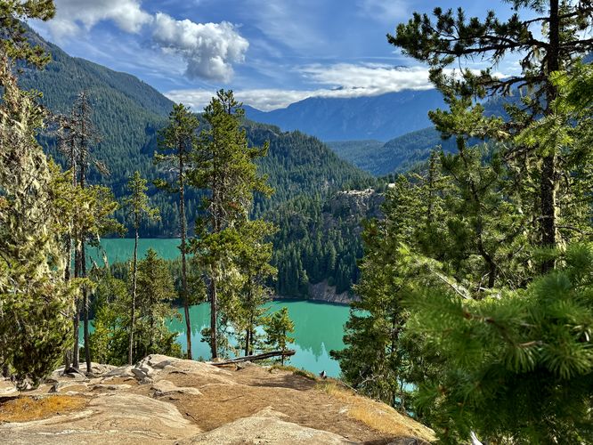 View of the water with the ultra-popular Diablo Lake Overlook across the water