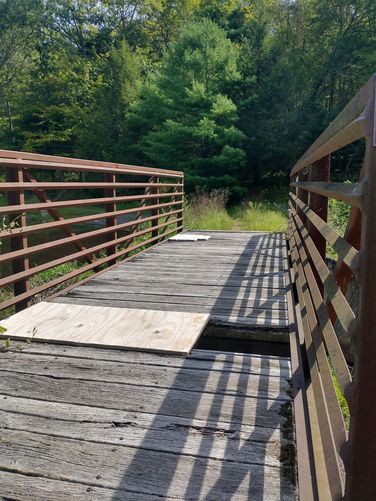 Use caution when crossing the bridge as it is in need of repair.