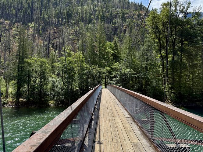 Hiking across the Trail of the Cedars suspension bridge
