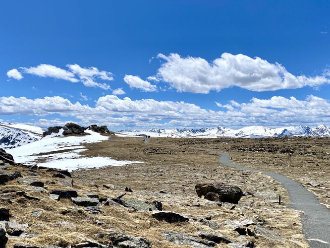 Trail view with snow-capped alpine mountains in the distance