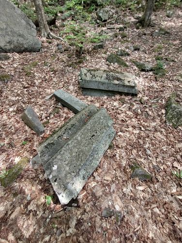 Columns of stone that have broken off  of the larger face