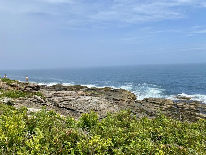 View of the rocky coastline and waves crashing from the tril