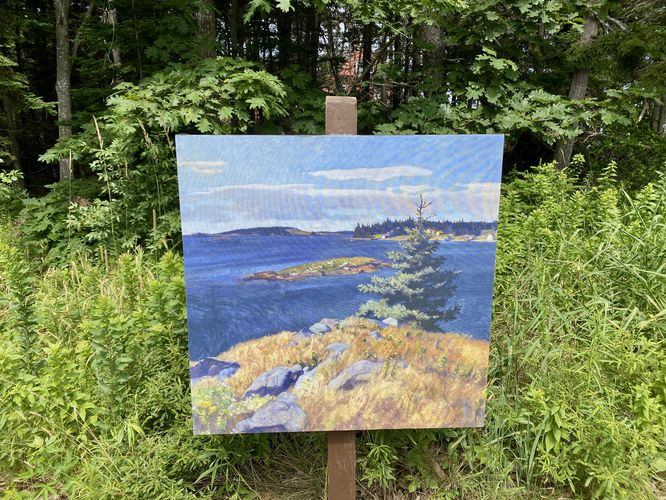 Re-printed painting on a stand on-trail of a bay with evergreen in the foreground