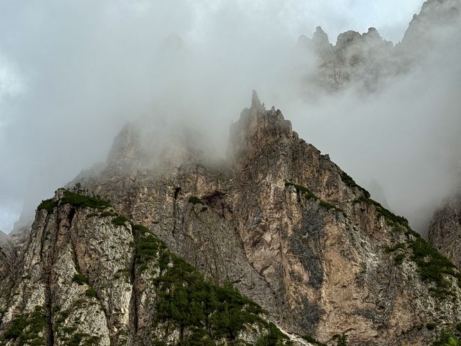 Limestone cliffs and peaks standing in clouds, in the Dolomites