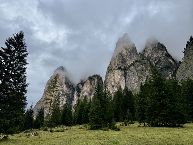 Moody clouds sit over towering alpine peaks of Vallunga