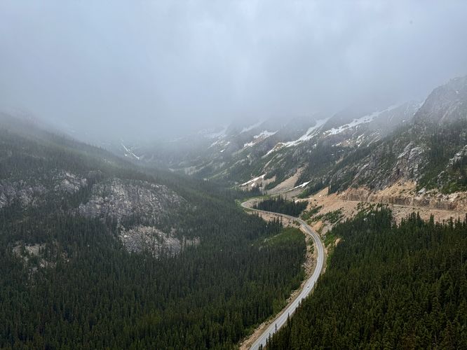 Cloudy view of the North Cascades Highway and alpine slopes